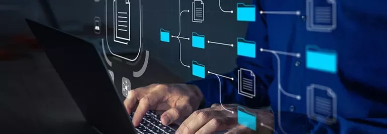 Person working on laptop with digital folder and document icons.