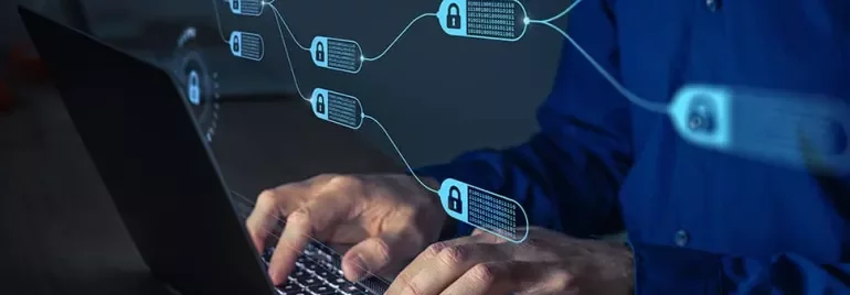 Person typing on laptop with digital blockchain links and padlocks in the foreground.