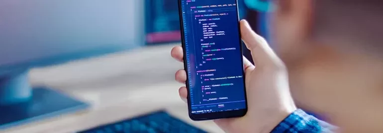 Person holding smartphone displaying code