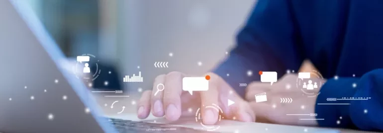 Person typing on laptop with digital icons overlay