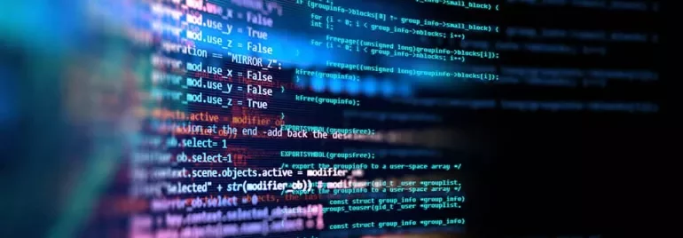 Close-up of computer code displayed on a screen with a colorful background.